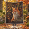 Woven cotton blanket featuring a red fox surrounded by autumn leaves in warm woodland tones