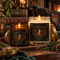 Foxfire Retreat woodland candles in 4oz amber and 9oz clear glass vessels with ornate fox botanical labels in a cozy fireside living room.