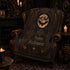 Victorian gothic Halloween velveteen blanket with full moon bats pumpkins skull and ornate botanical design living room. blanket is laying across a leather chair.