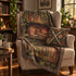 A cosy living room scene with a beige armchair draped in a printed throw blanket featuring a sleeping red dragon on bookshelves, alongside a matching floral accent pillow with crossed medieval swords. The room includes bookshelves, plants, and warm window light.