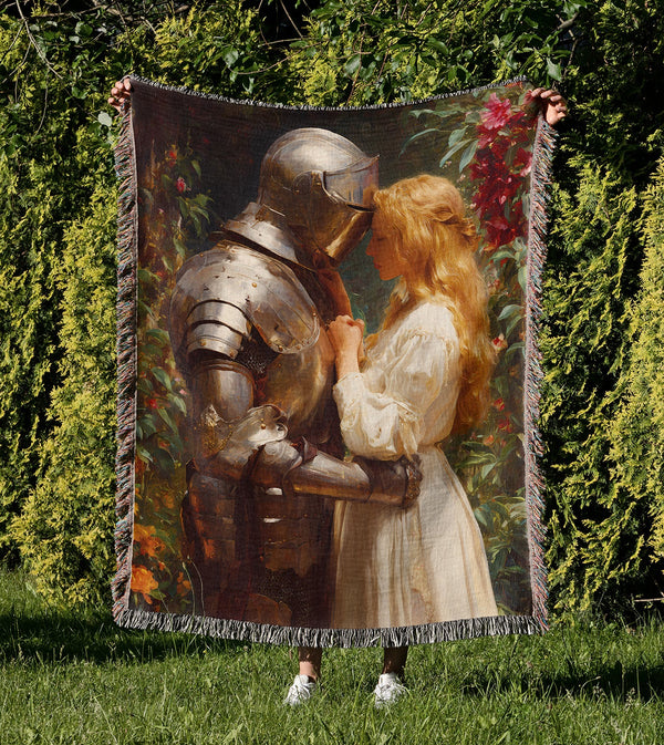 Knight and maiden woven cotton blanket with medieval romantic artwork and colourful fringed edges held outdoors